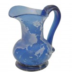 Free-blown pitcher with applied foot and handle.