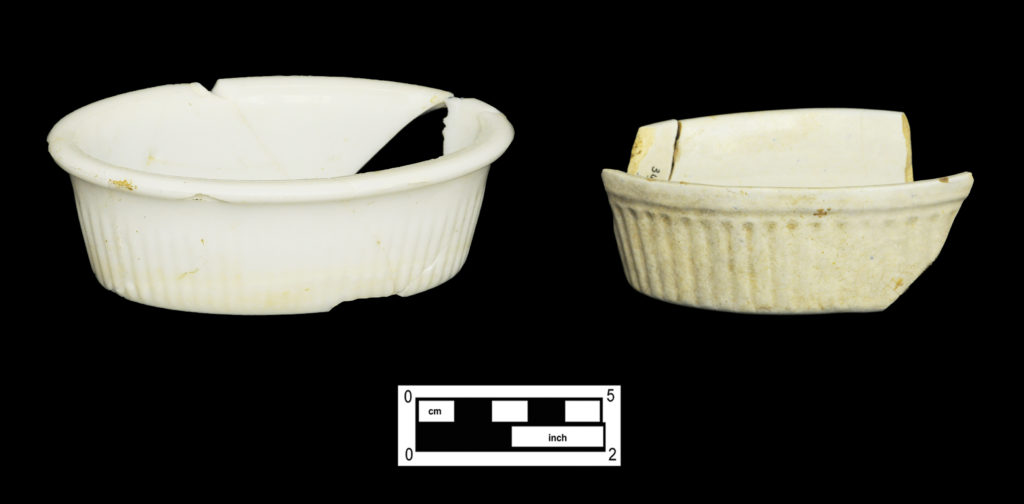 Two bird cage baths, one pressed from opaque white glass and the other made of refined earthenware (4A-G-0293 and 4A-C-0086).