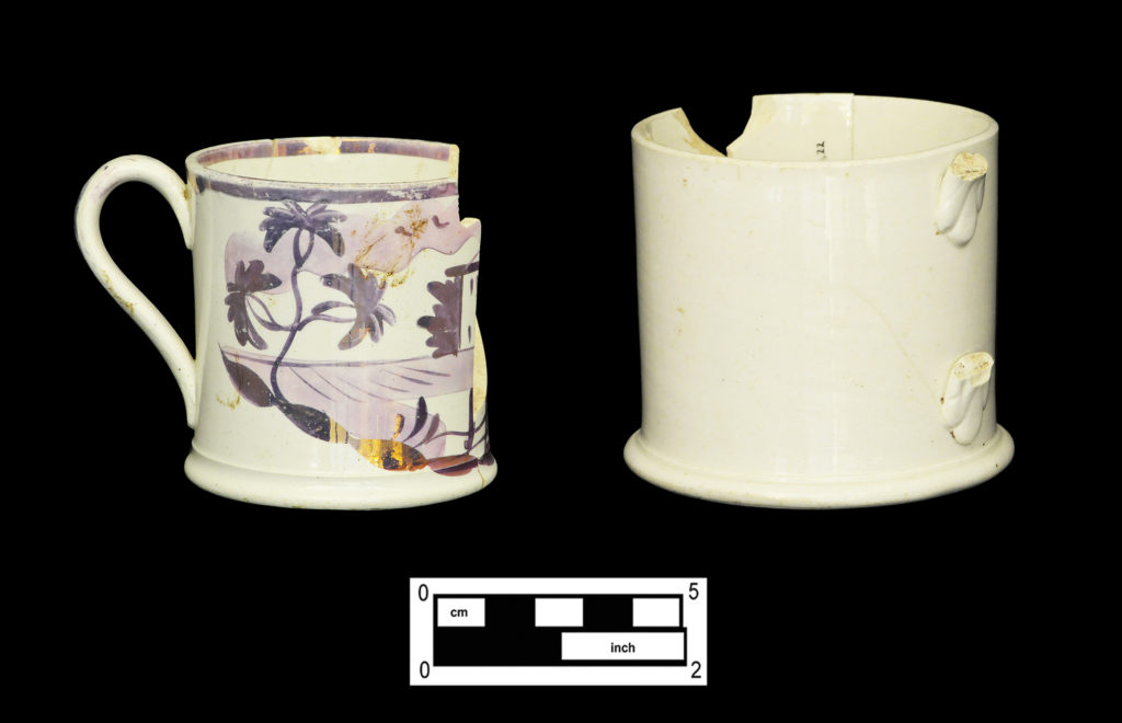 Child’s size pearlware mug with hand-painted purple luster “cottage” motif (4A-C-0111); plain pearlware or whiteware mug with foliate handle attachments (4A-C-0026). 