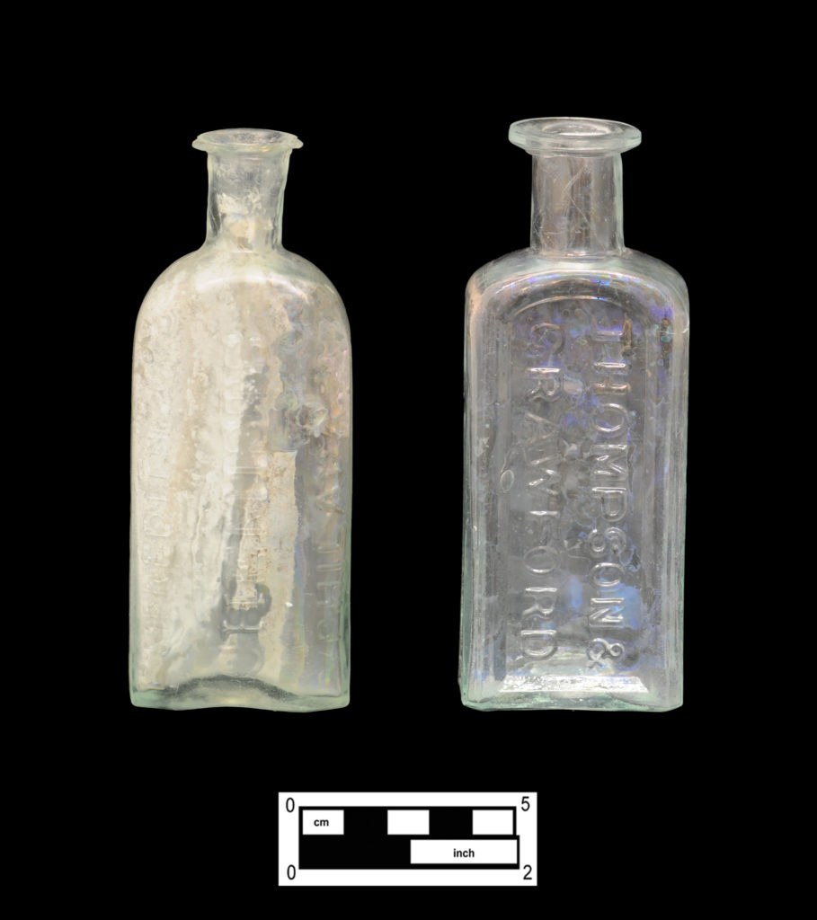 1018 Palmer Street Druggist Bottles: Edwin Meredith & Co. bottle (left, 4A-G-0018) and Thompson & Crawford bottle (right, 4A-G-0275)